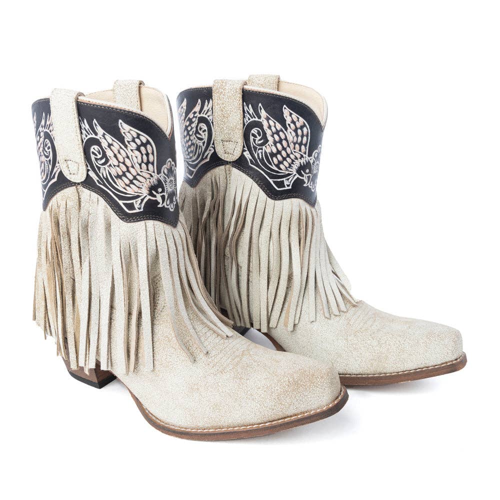 Cream ankle booties featuring dramatic fringe and angel wing embroidery on a black leather upper with a Western riding heel.