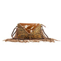 Leather and hairon bag featuring a textured design, tan color, and fringed detailing, perfect for Western-style outfits.