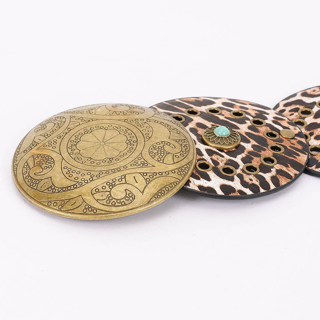 Close-up of faux leather disc belt with decorative metal discs and small stone embellishments in bohemian style