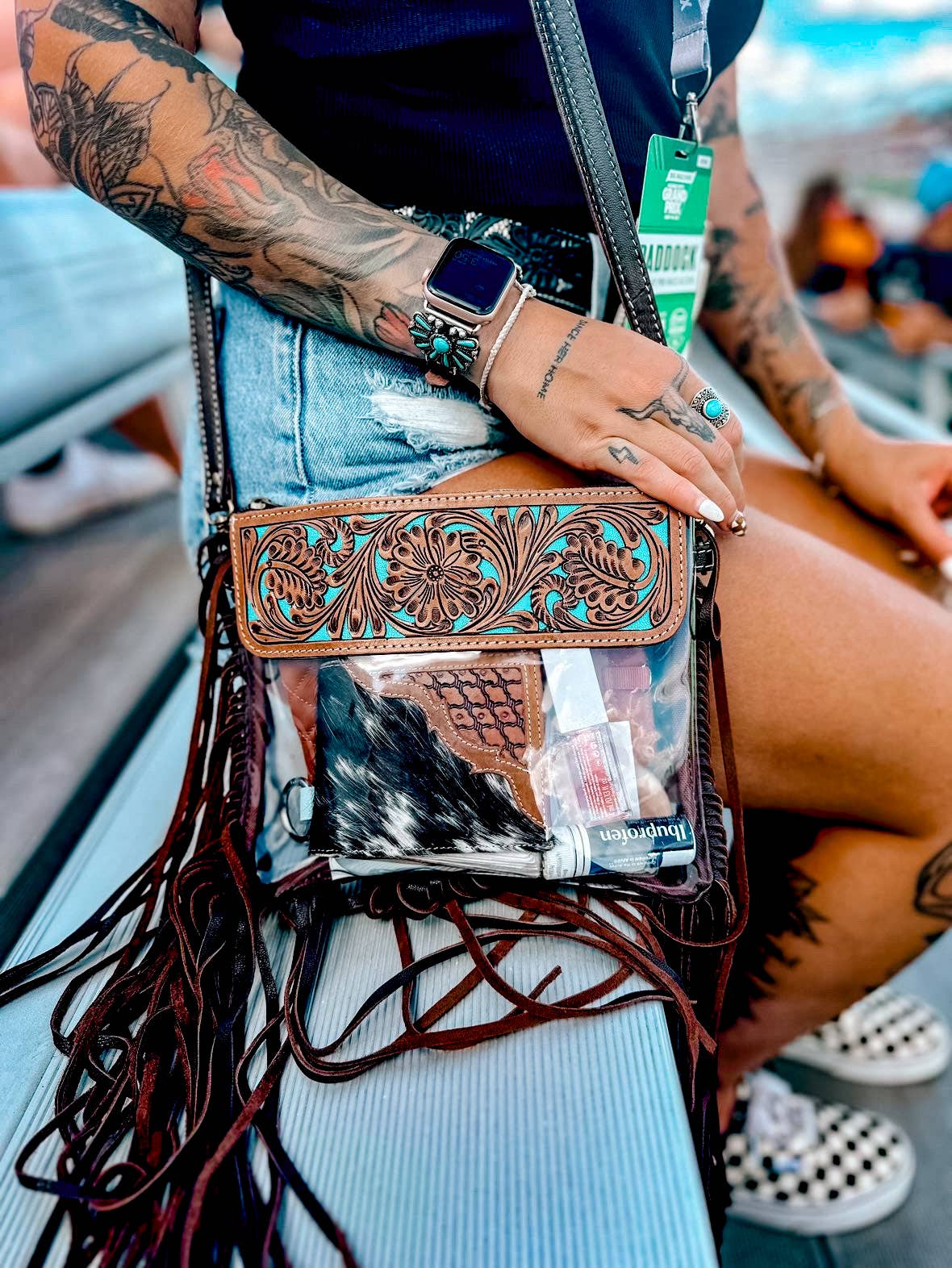 Hand Tooled Clear Purse Crossbody featuring genuine hair-on cowhide and decorative turquoise accents, worn with fringe detailing.