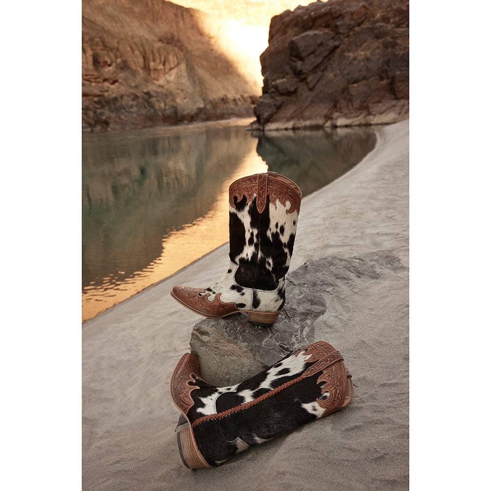 High top cowboy boots featuring black and white hair-on hide, brown hand-tooled leather, and a snip toe design.