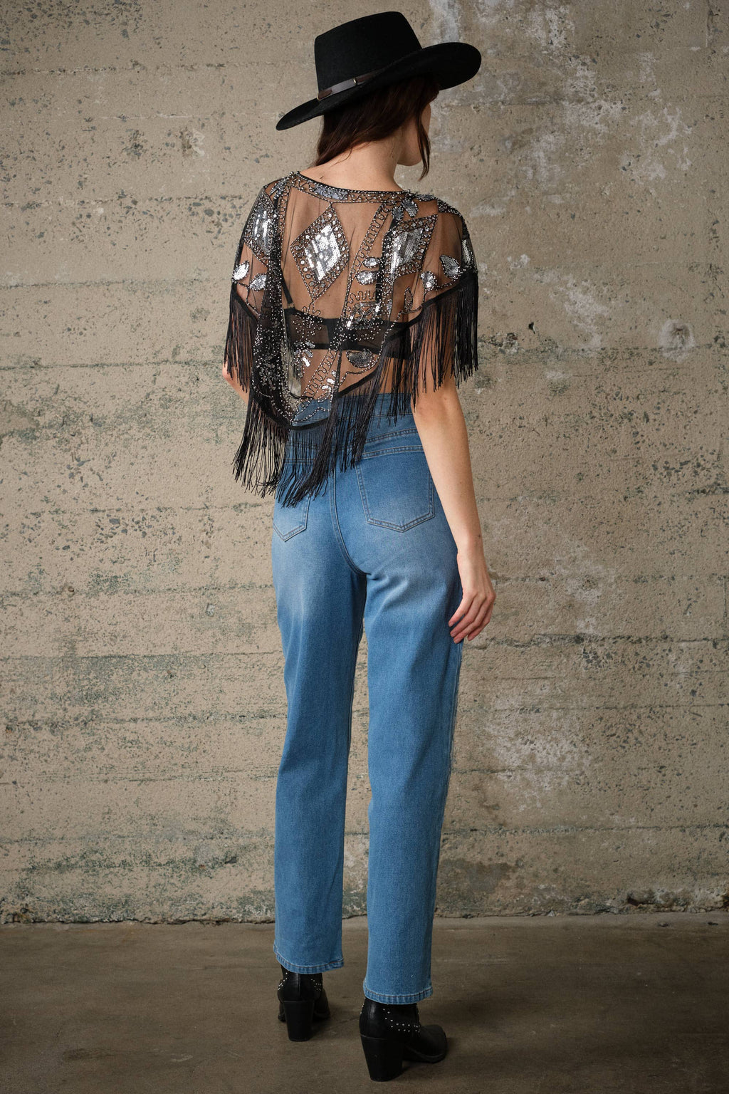 Sheer black mesh cape with sequin and bead embellishments, dramatic fringe trim, and open front design.