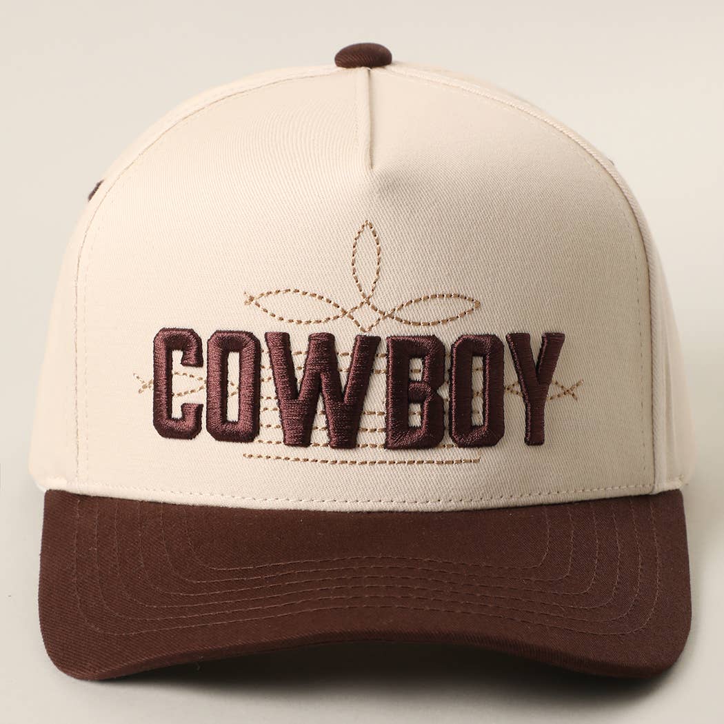 Cream-colored trucker hat featuring bold "COWBOY" 3D embroidery with brown accents and a pre-curved visor.