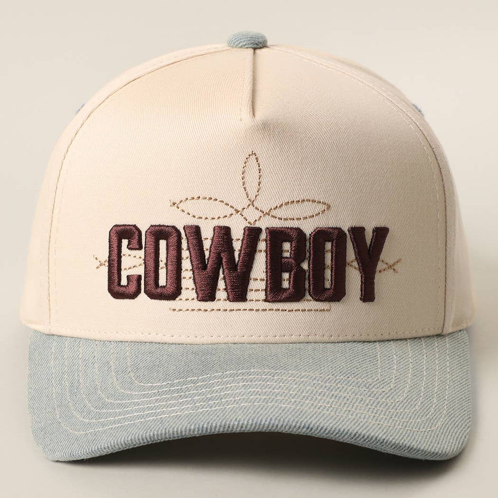 Two-tone trucker hat with "COWBOY" 3D embroidery, cream front, blue denim visor, and relaxed fit. Adjustable snapback.