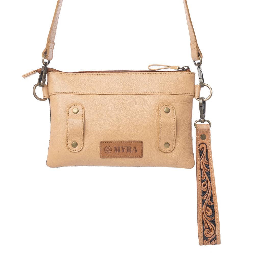 Ochre frost leather belt bag featuring hand-tooled trim, detachable wristlet, and adjustable strap for versatile styling.