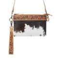 Compact leather bag featuring a textured black and white hairon pattern, with hand-tooled floral detailing on the top trim.