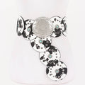 Black and white faux leather disc belt with decorative metal elements and turquoise stone accents