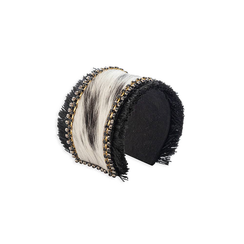 Hair-on hide cuff bracelet in black and white, accented with onyx stones and silver beads, featuring fringe detail.