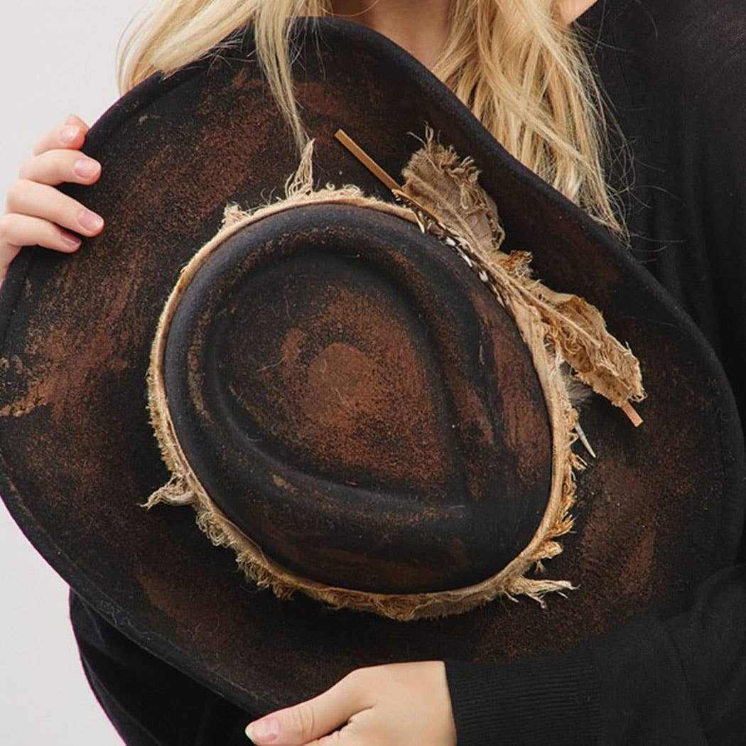 Vintage cowgirl and fedora hat with feather and distressed fabric band, shapeable and versatile accessory.