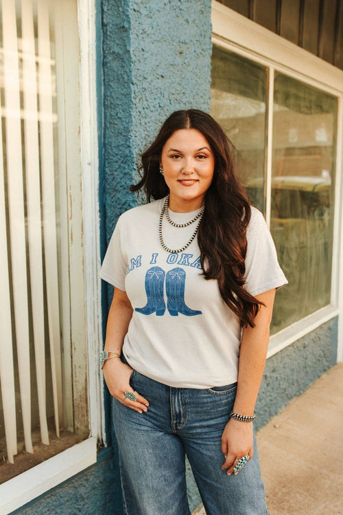 Woman wearing Am I Okay Graphic Tee with blue cowboy boots print and casual jeans