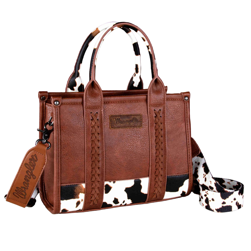 Brown simulated leather tote with cow print, whipstitch details, top zipper, double handles, and detachable crossbody strap.