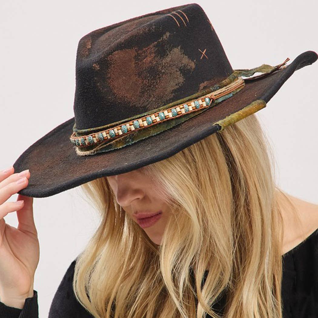 Vintage versatile shapeable cowgirl and fedora hat with distressed band and decorative beads worn by blonde woman