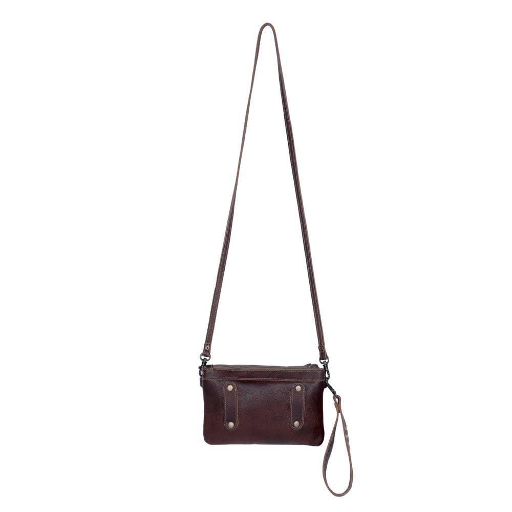 Chic brown hairon leather belt bag with hand-tooled details, featuring dual straps for versatile wear.