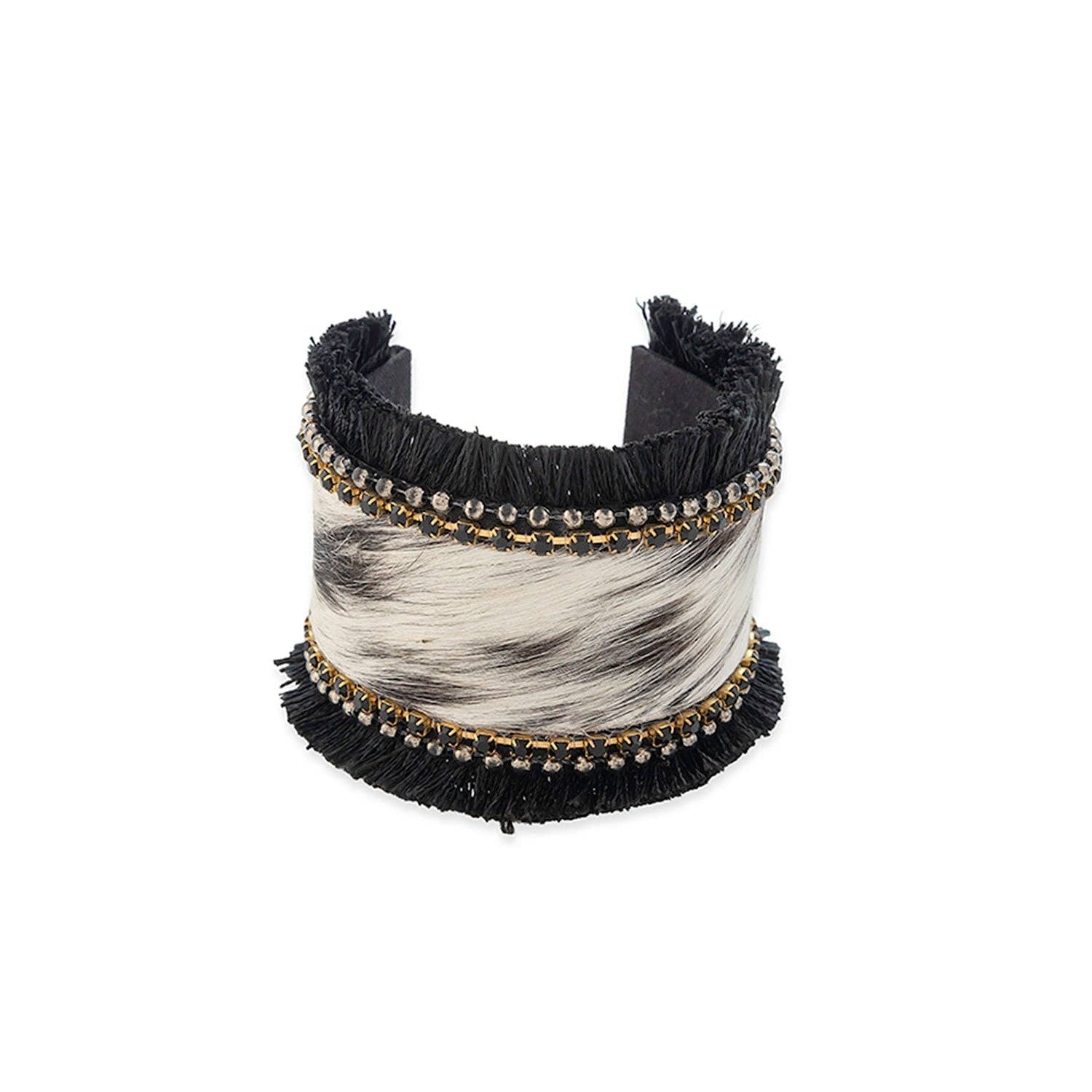 Cuff bracelet featuring hair-on hide with black fringe, embellished with onyx stones and silver beads. Diameter 2.5 inches.