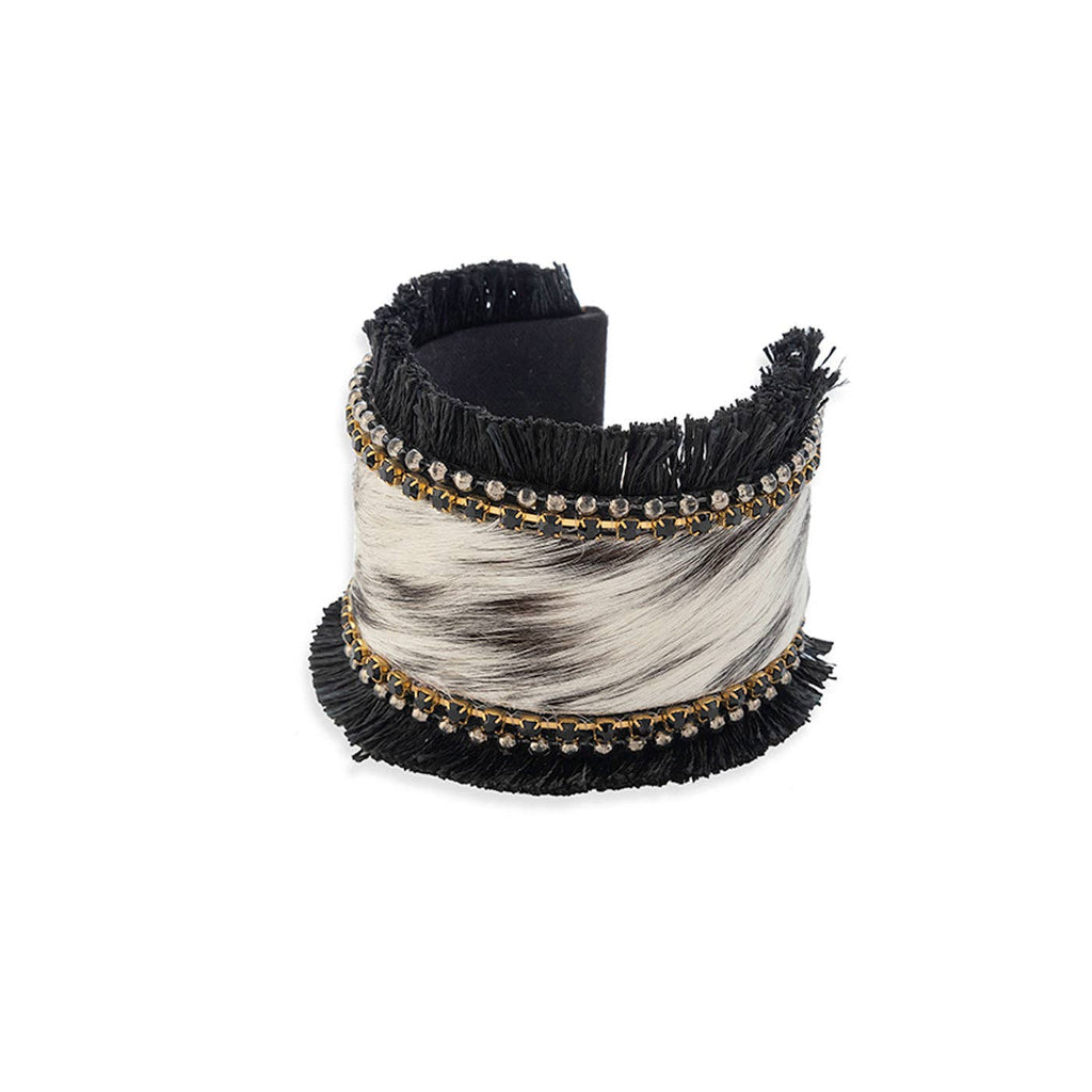 Hair-on hide cuff bracelet featuring black fringe and onyx stones, with a soft, textured appearance. Diameter: 2.5 inches.