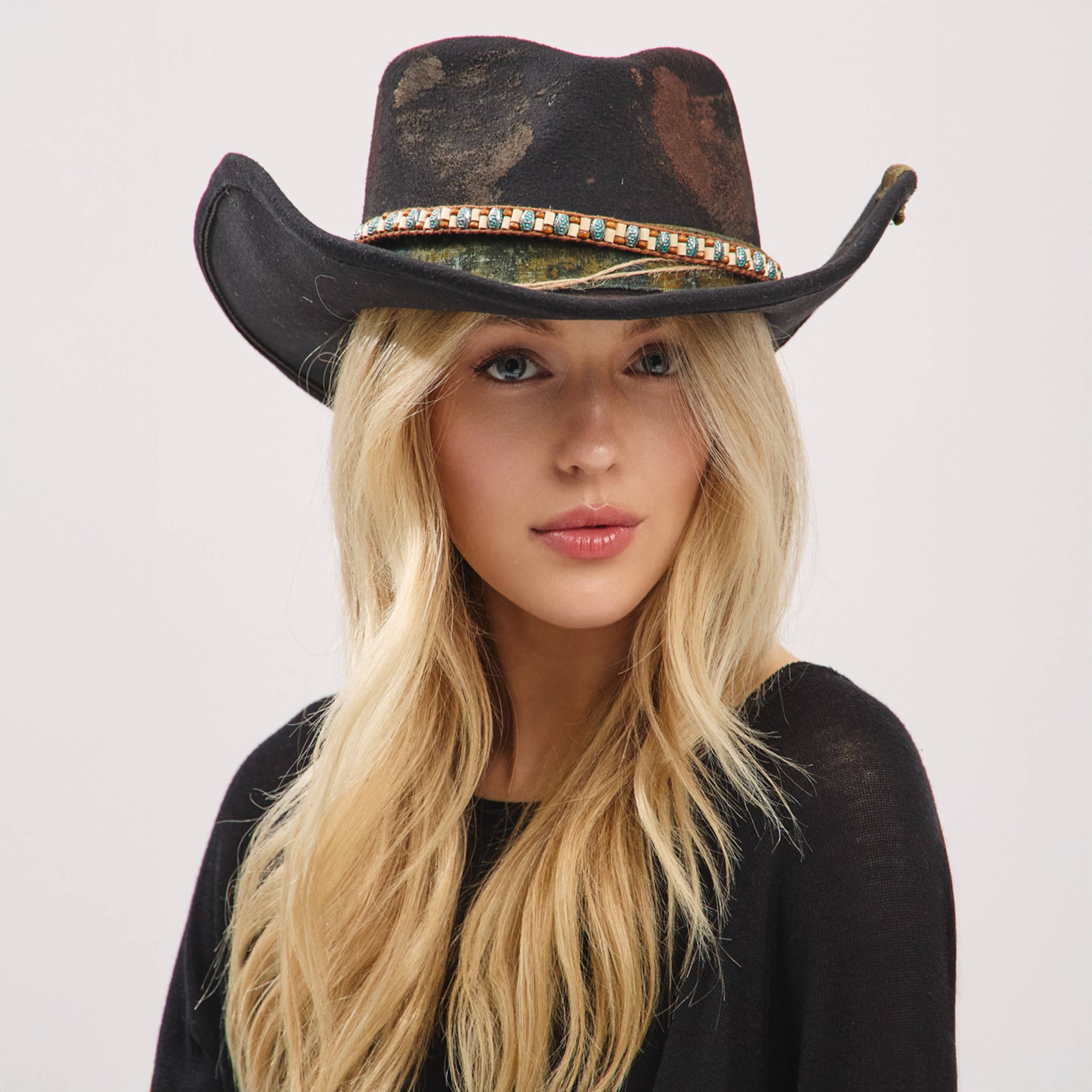 Black distressed fabric cowgirl fedora hat with a rustic band and shapeable brim, worn by a model with long blonde hair.