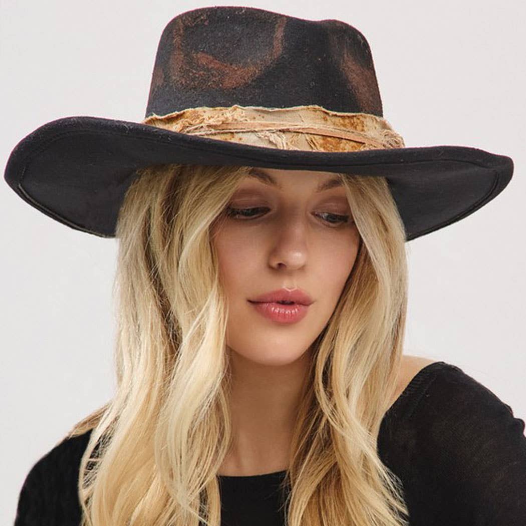 woman wearing vintage versatile shapeable cowgirl and fedora hat with feather and distressed fabric band