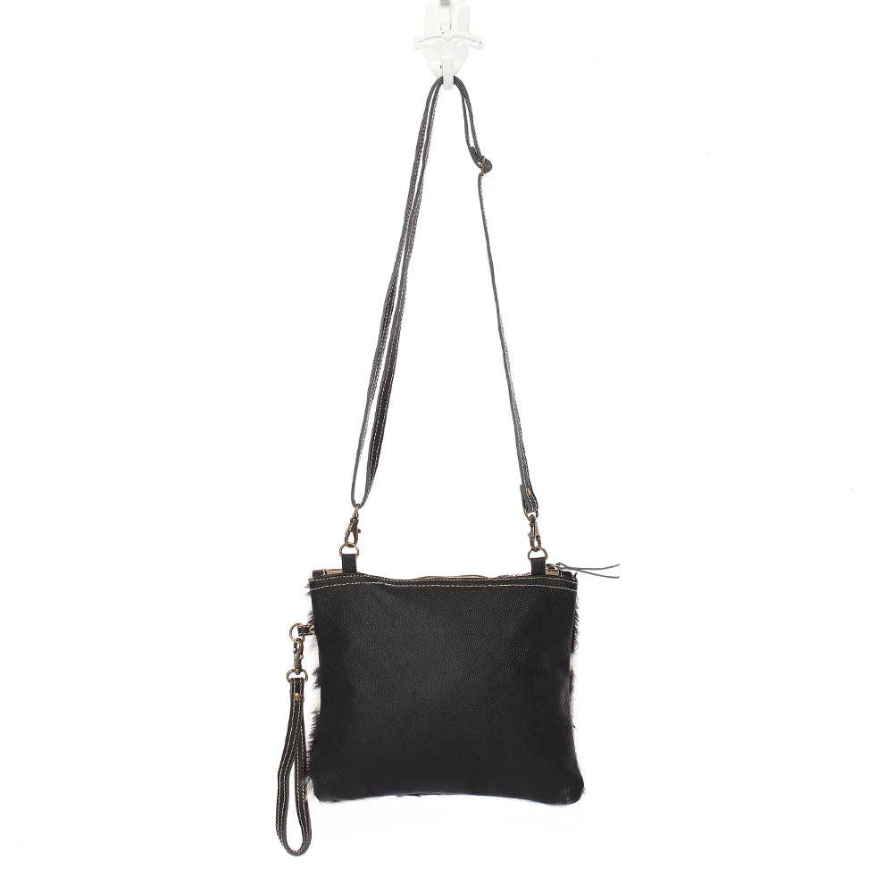 Black Myra Hairon Cowhide Bag featuring genuine leather and a bold animal print design, adjustable crossbody straps.
