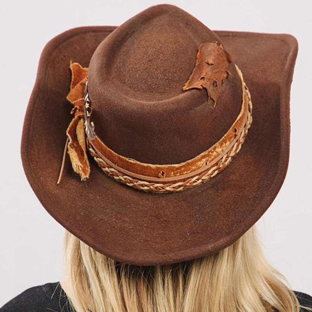 Vintage versatile shapeable cowgirl and fedora hat with feather and distressed fabric band in brown polyester