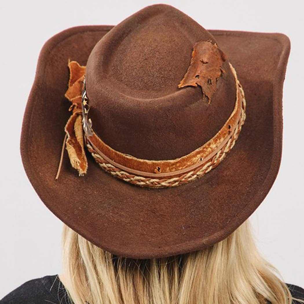 Vintage versatile shapeable cowgirl and fedora hat with feather and distressed fabric band in brown polyester
