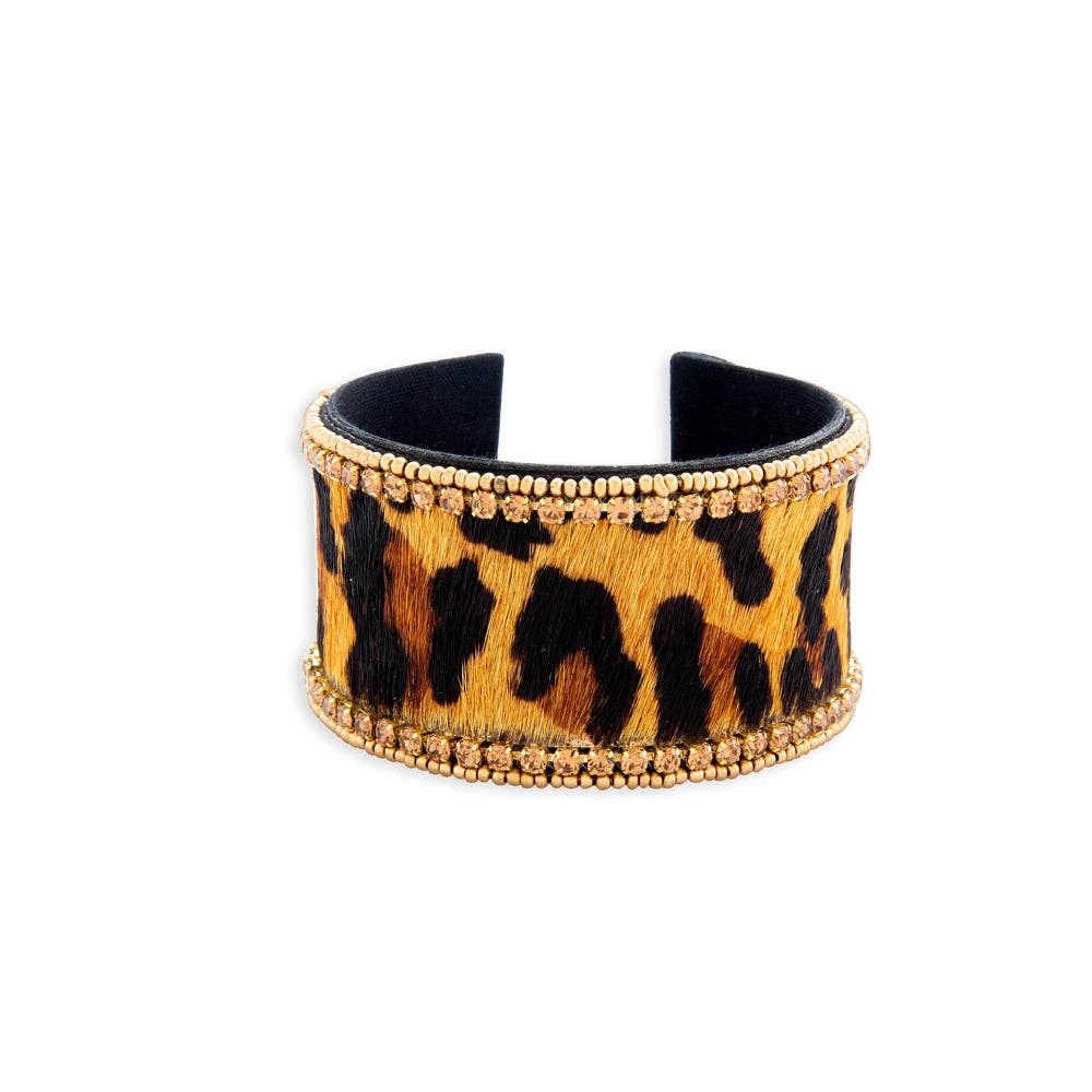 Chunky animal print bracelet with gold detailing, featuring leather, glass, and fabric materials. Diameter 2.5 inches.