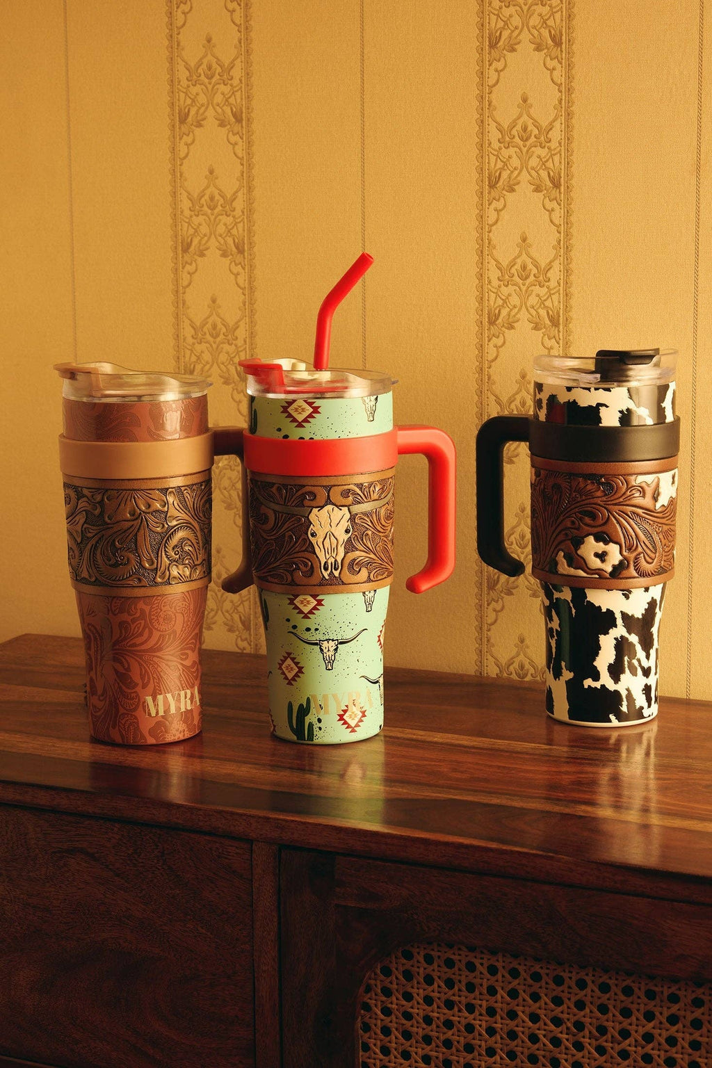 Black and white cowhide patterned wide tumbler featuring tooled leather accents and an ergonomic handle.
