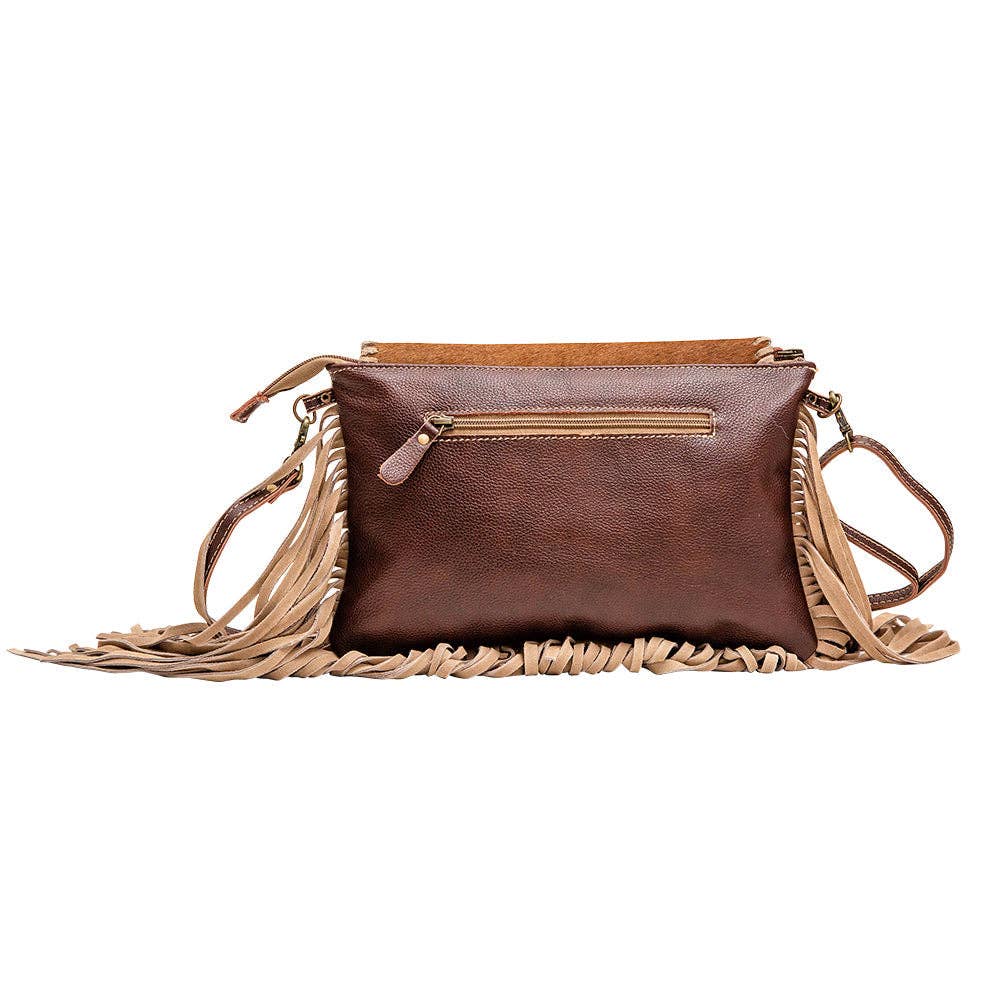 Brown leather and hairon bag with fringed accent; features a zip pocket and a detachable strap. Dimensions: 12x8 inches.