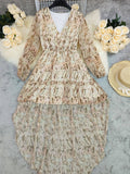 V-neck, layered bohemian dress in soft beige with floral print, featuring long sleeves and a flowy silhouette.