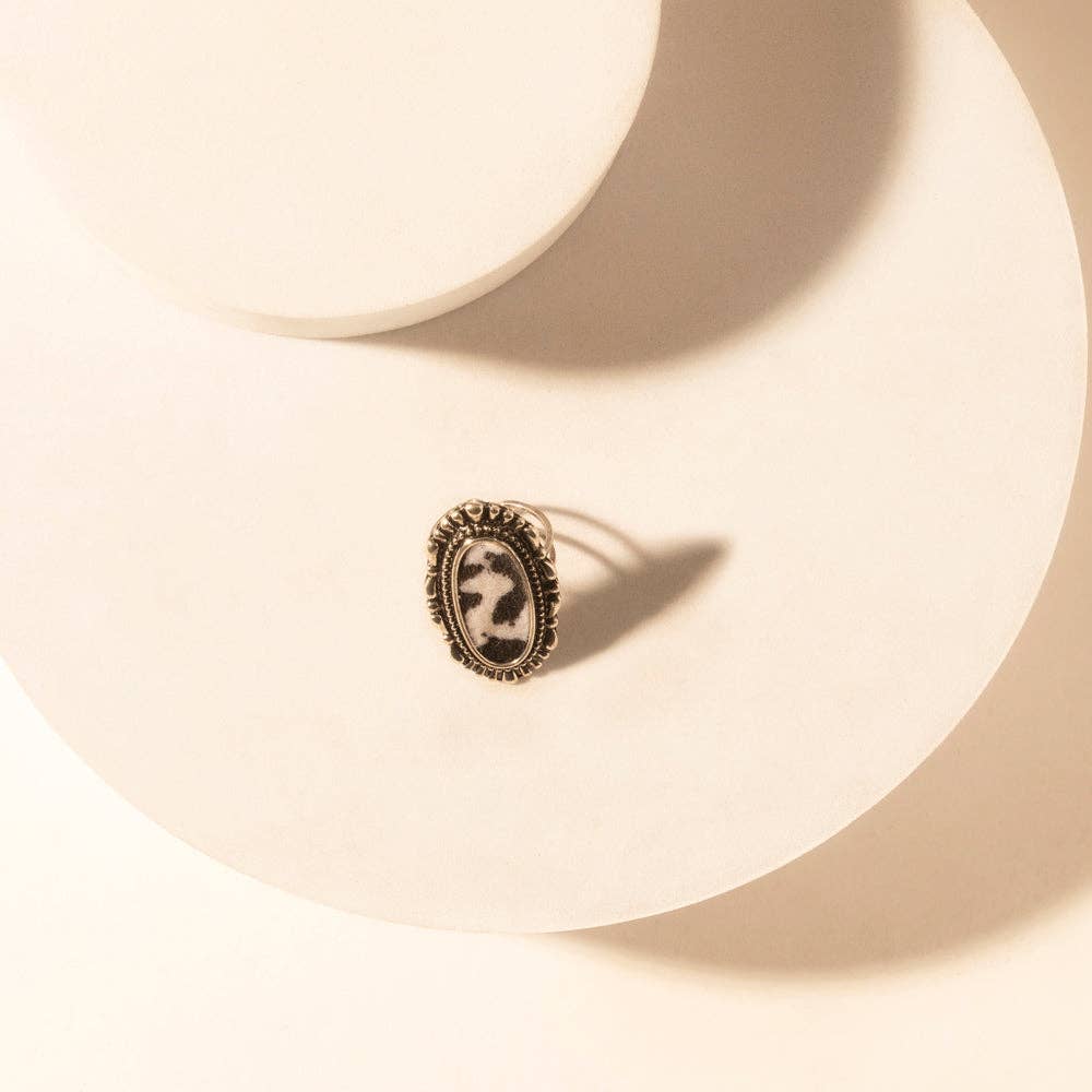 Adjustable ring with a bold oval shape, featuring a hair-on cowhide detail and a textured zinc alloy frame.
