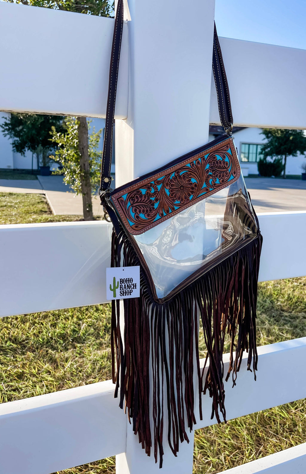 Hand Tooled Clear Purse Crossbody featuring a clear vinyl body, brown leather fringe, and intricate turquoise floral design.
