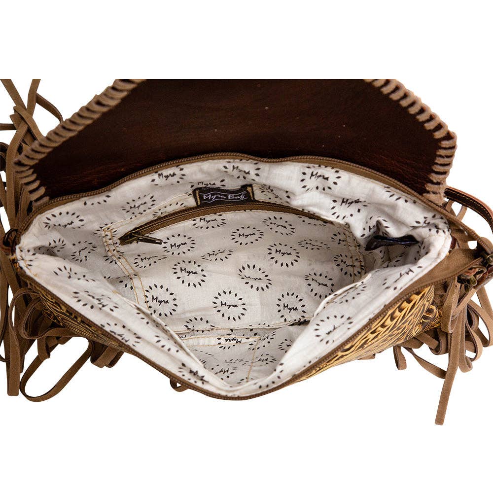 Interior view of the Harappa Leather & Hairon Bag shows a patterned lining, a zippered pocket, and fringe details.
