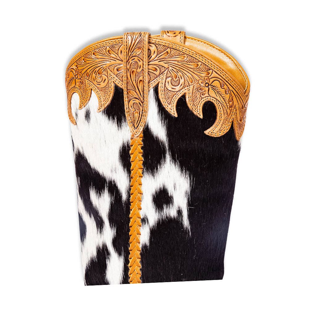 Hair-on leather high top boots featuring a black and white pattern, hand-tooled honey leather detail, and tapered heel.