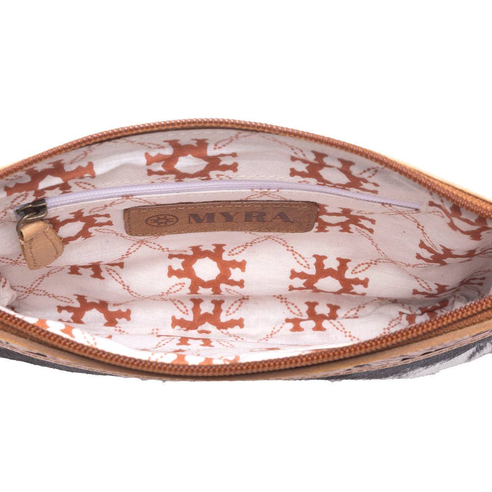 Inside view of the Stone Barrow Hairon Leather Bag in Ochre Frost, featuring a patterned lining and a zipper pocket.