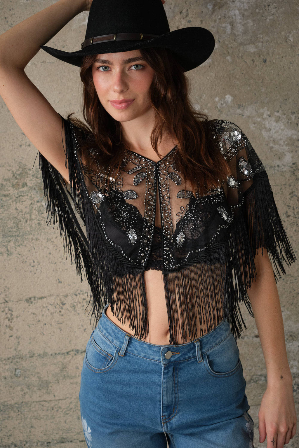 Sheer black mesh cape featuring sequin and bead details, dramatic fringe trim, and an open front design.