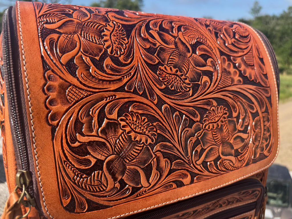 Fully Tooled Western Backpack with intricate floral embossing, crafted from genuine leather in a warm brown tone.